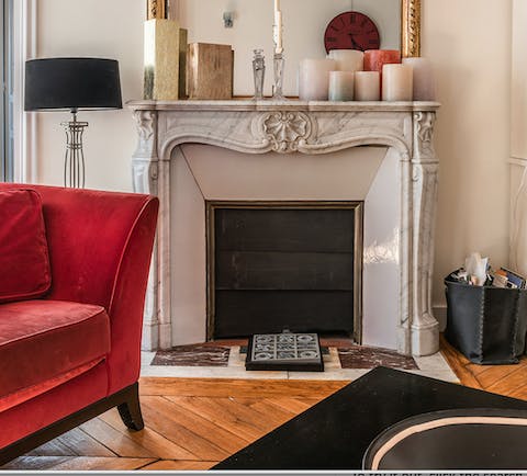 The marble fireplace and herringbone parquet